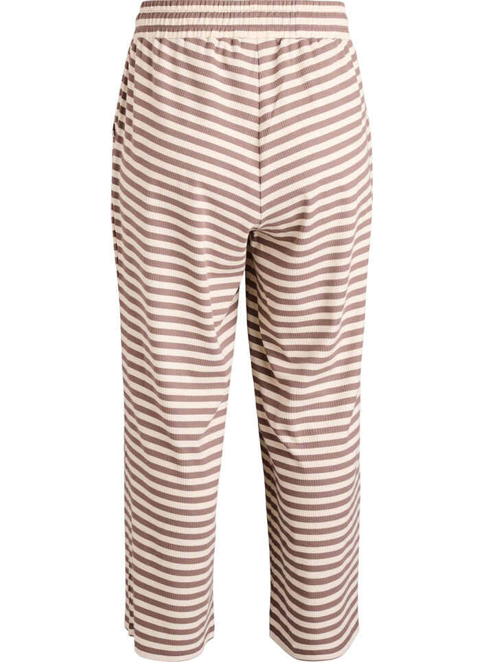 Raidalliset pyjamahousut korkealla vy&ouml;t&auml;r&ouml;ll&auml; ja leveill&auml; lahkeilla, Beige, Packshot image number 1