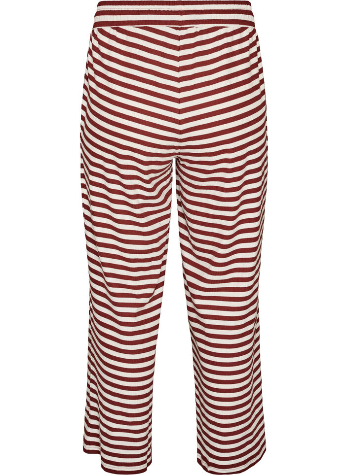 Raidalliset pyjamahousut korkealla vy&ouml;t&auml;r&ouml;ll&auml; ja leveill&auml; lahkeilla, Punainen, Packshot image number 1