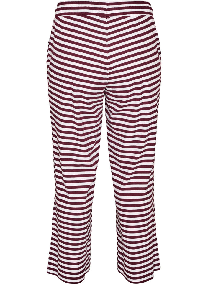 Raidalliset pyjamahousut korkealla vy&ouml;t&auml;r&ouml;ll&auml; ja leveill&auml; lahkeilla, Punainen, Packshot image number 1
