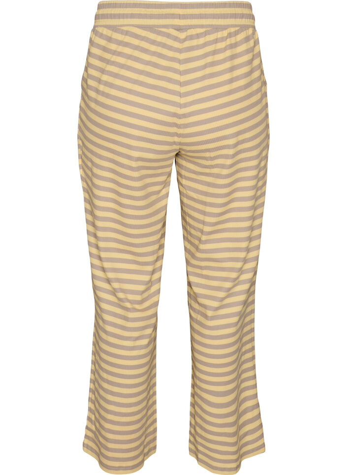Raidalliset pyjamahousut korkealla vy&ouml;t&auml;r&ouml;ll&auml; ja leveill&auml; lahkeilla, Keltainen, Packshot image number 1