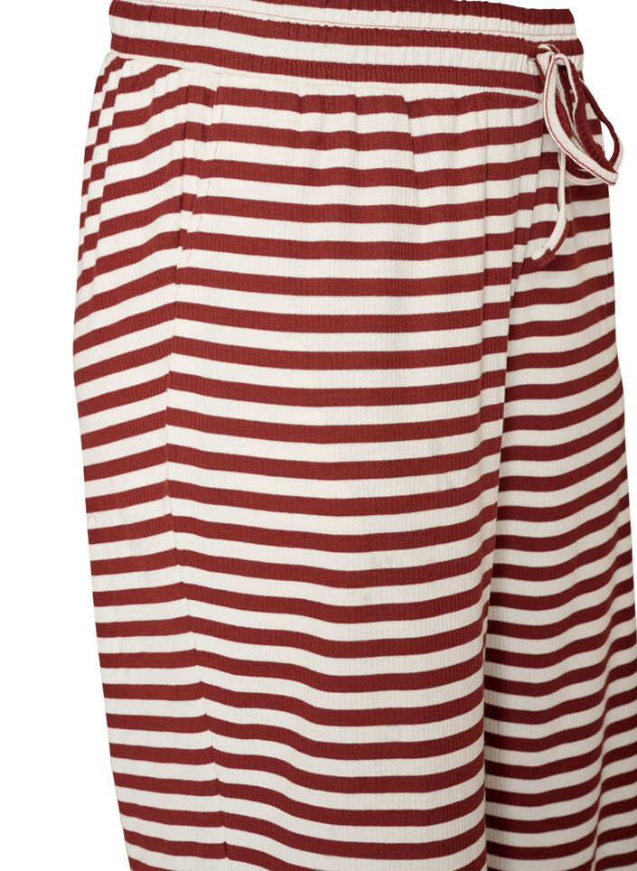 Raidalliset pyjamahousut korkealla vy&ouml;t&auml;r&ouml;ll&auml; ja leveill&auml; lahkeilla, Punainen, Packshot image number 2